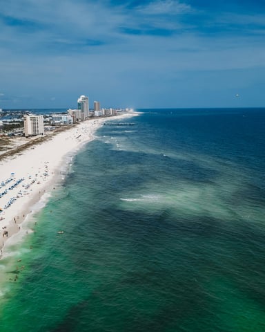 Aerial view of Orange Beach coastline with white sand and turquoise Gulf water