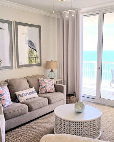 Coastal living room with ocean view through balcony doors
