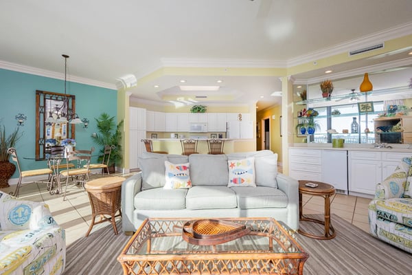 Covered waterfront porch with lounge chairs, white railings, and expansive bay views